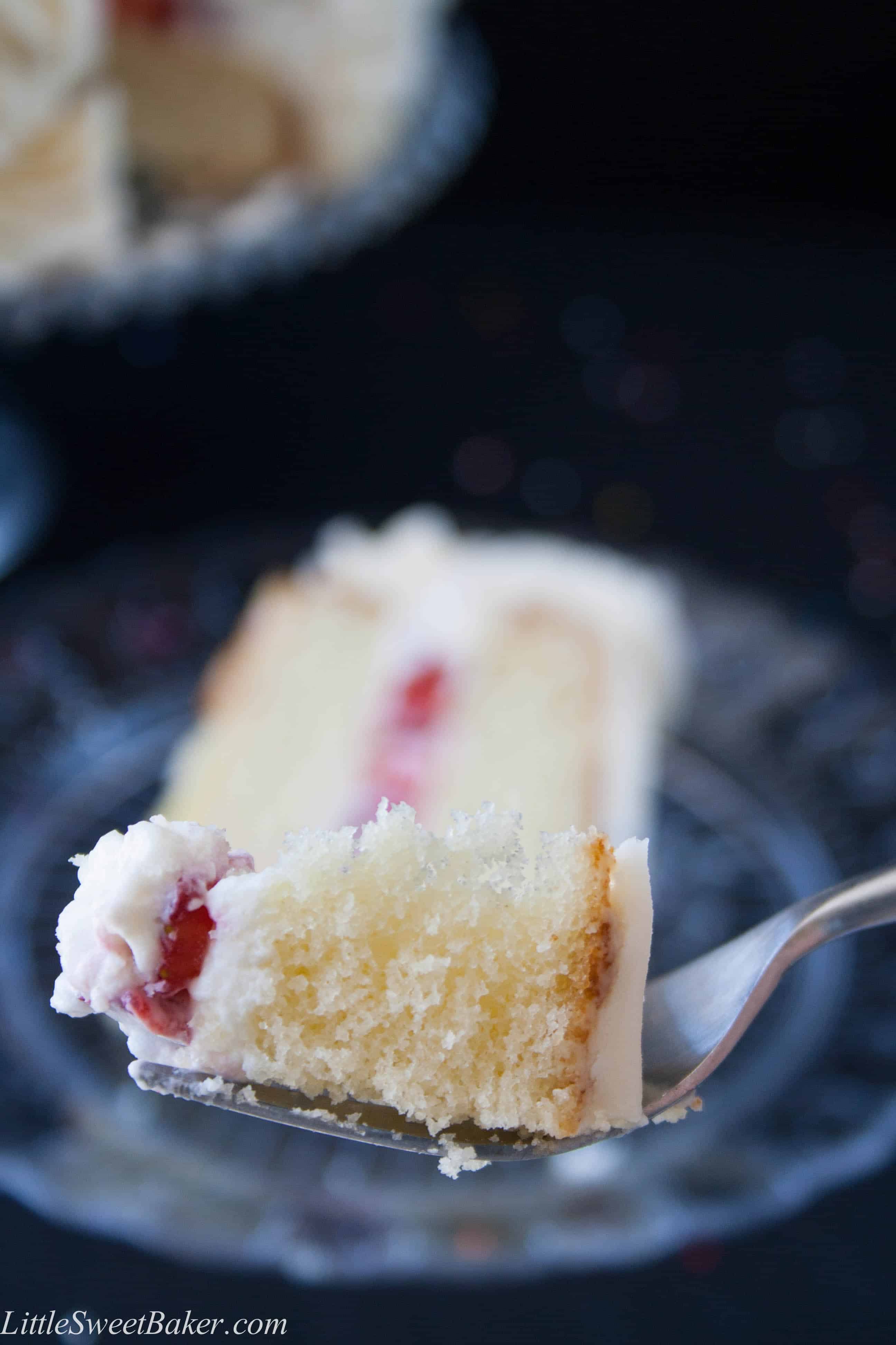 Moist and fluffy vanilla cake with strawberries and cream filling, surrounded with vanilla buttercream.