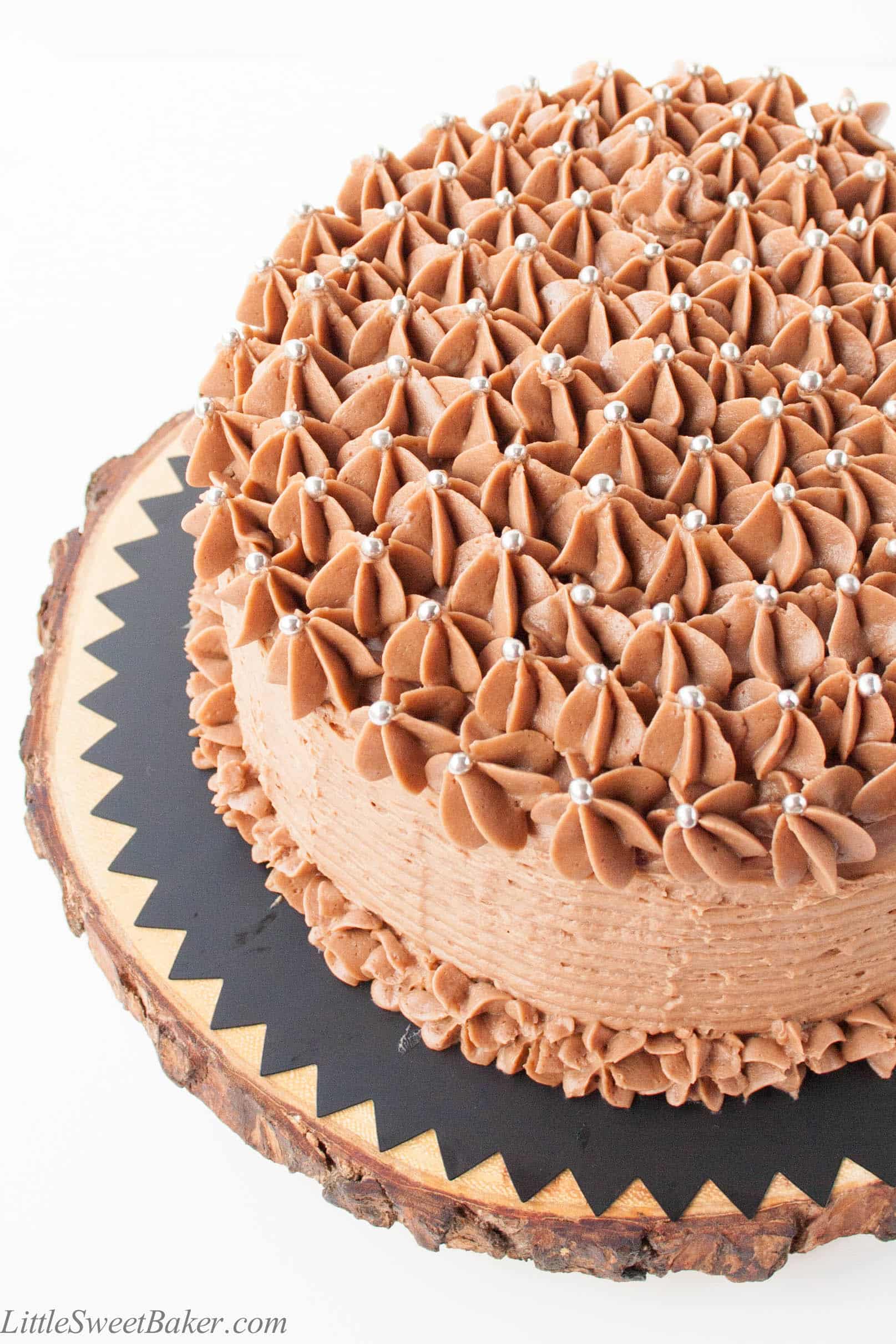 BANANA CHOCOLATE CHIP CAKE WITH MILK CHOCOLATE FROSTING. A deliciously moist chocolate chip banana cake surrounded with a real milk chocolate buttercream.