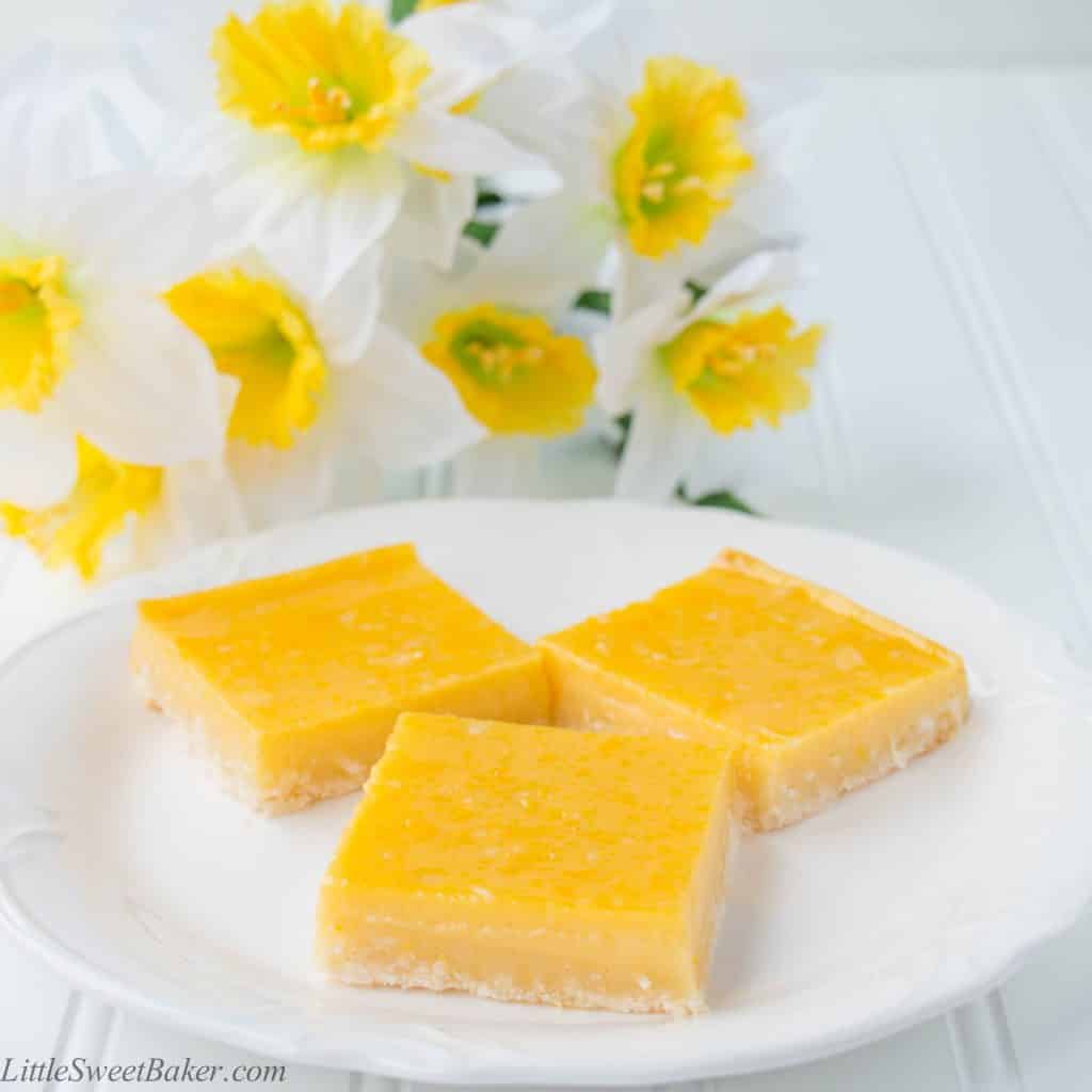 These heavenly tropical bars are made up of a tender crumbly coconut shortbread crust and topped with a fruity pineapple mango custard.